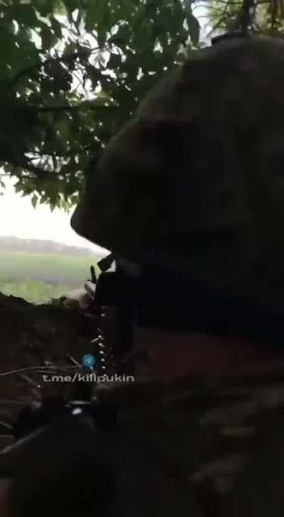 Ukrainian Azov fighter firing from a German MG3 machine gun at Russian forces in the Eastern Front