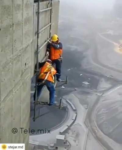 Crazy scaffolders dismantling a hanging scaffold