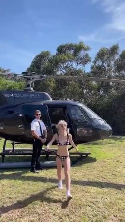 Kiernan Shipka, coming out of a helicopter in a bikinee