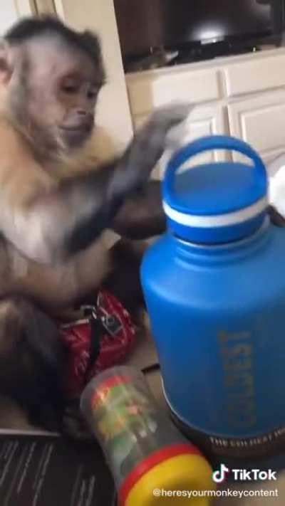 George unboxing a water bottle.