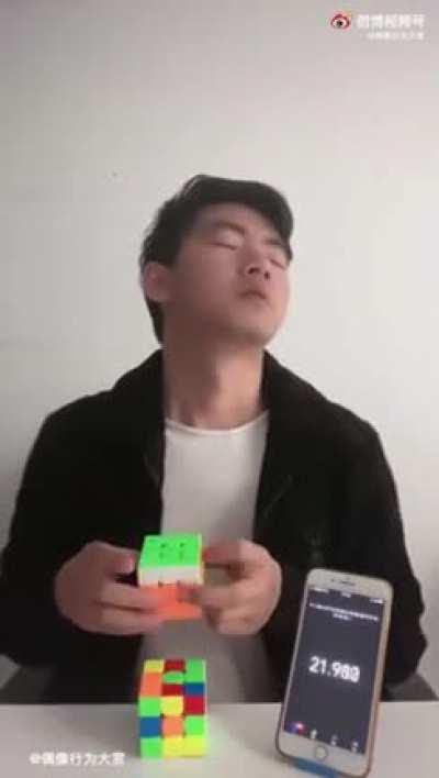 Man trying to solve a Rubik's Cube blindly, but in a different way