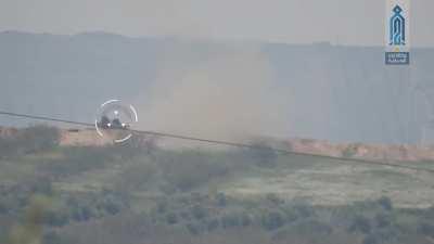 HTS fighters hit a regime T-72 with a TOW missile right after it fires. Northern Hama, Syria. 2017/04/17.