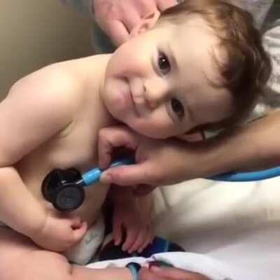 Sweet baby boy rests head on nurse's hand...!