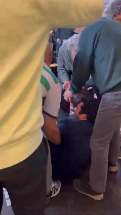 French pro israel clown screaming and crawling on the floor pretending to be attacked In the middle of a Pro Palestine protest