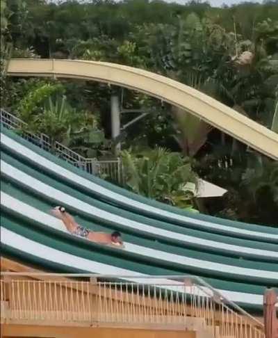 Man descends waterslide headfirst, executes impressive flip &amp; dive