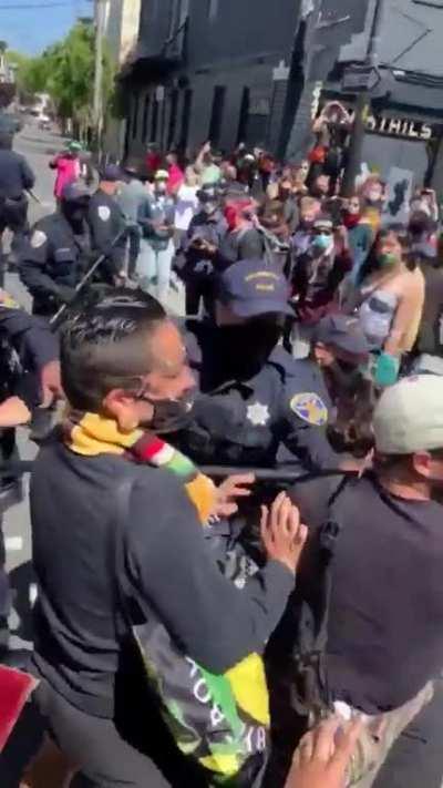 San Francisco Police Officer is sprayed with spray paint at “Pride is a Riot” demonstration