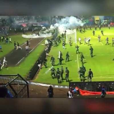 Rioters clash with police at a football game in Indonesia