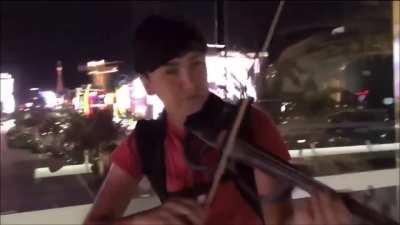 Alex Rivers, Las Vegas based violinist performing over an overpass. His social is @alexriversmusic