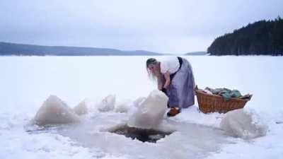 3 feet of ice and snow can not stop a Siberian woman from her chores. Respect!