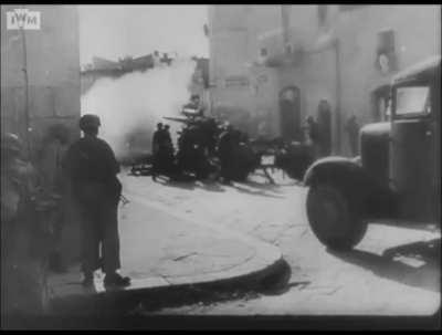 StuG and Fallschirmjäger with 88mm Flak guns engaged in street fighting during the Battle of Ortona in December 1943