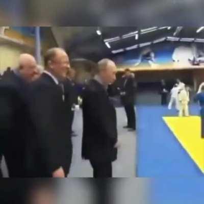 Putin teaches a kid some martial arts.