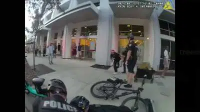 Orlando cop violently shove female protester to ground claiming, she lunged towards officer and citizen in threatening manner. Eight people arrested, use-of-force investigation underway.