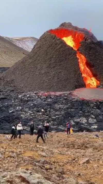 Casually playing volleyball as a volcano erupts in the background. What did you do for fun today-