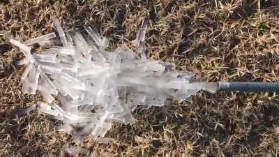 Frozen hose releasing ice