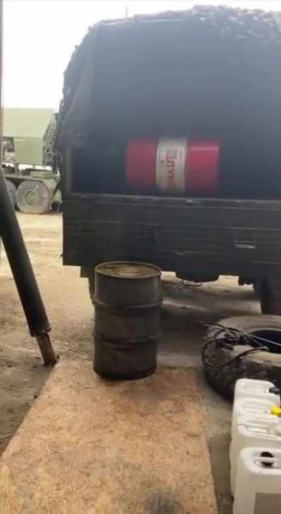 How russians unload their supply trucks of oil barrels 