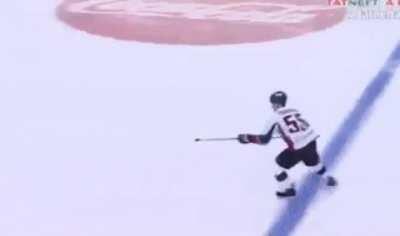 Russian hockey player puts the puck on the stick and throws it in the goal like a javelin