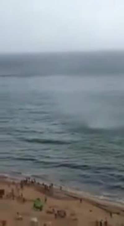 A sea tornado hits the shore of a Brazilian beach