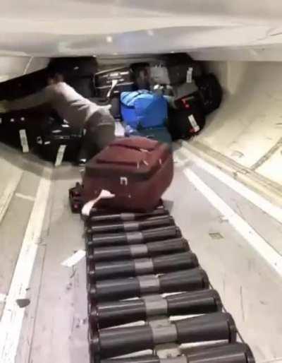 Piling up luggage in the compartment of an airplane.