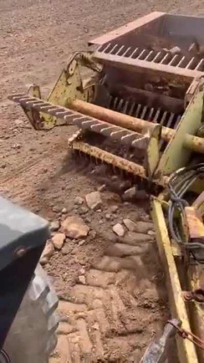 A device to clear rocks out of a field