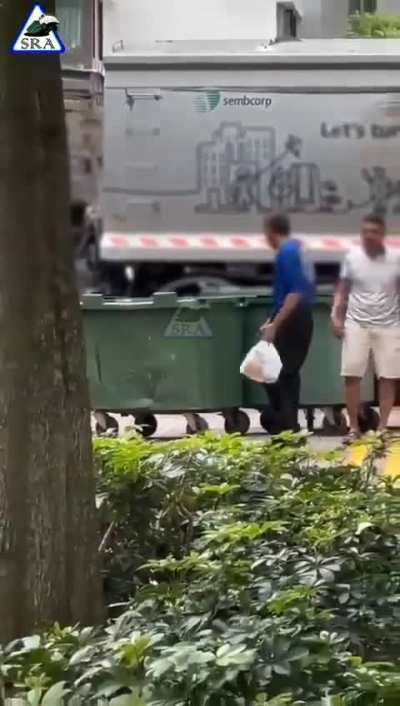 2 man puting another guy in the trash