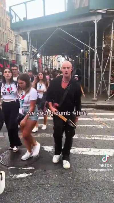 Let me just walk wrong way through a crowd and pretend to play guitar for a video