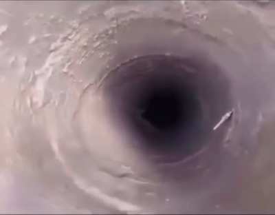 Singing Chinese man in a hole gets ice ball dropped on him 