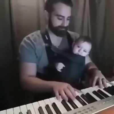 Dad playing music until his cute baby snoozes in Dreamland