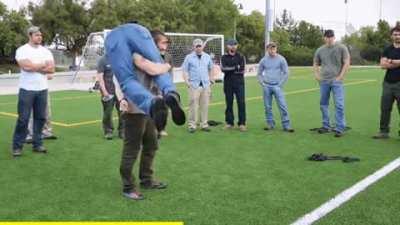 Former Army Ranger demonstrating how to pick up someone heavier than you