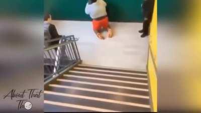 man attempts to jump over stairs