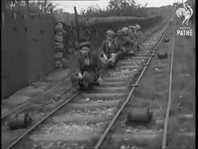 Small truck with handbrake used by quarrie workers to ride in between rails when returning from work in 1935