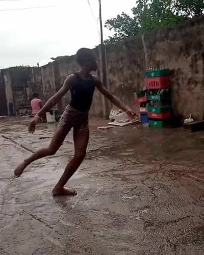 Anthony from Nigeria Dancing ballet barefooted on concrete while raining.