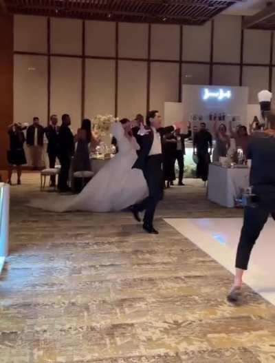 Energy of guests and grand entry of the couple at this wedding's dance floor