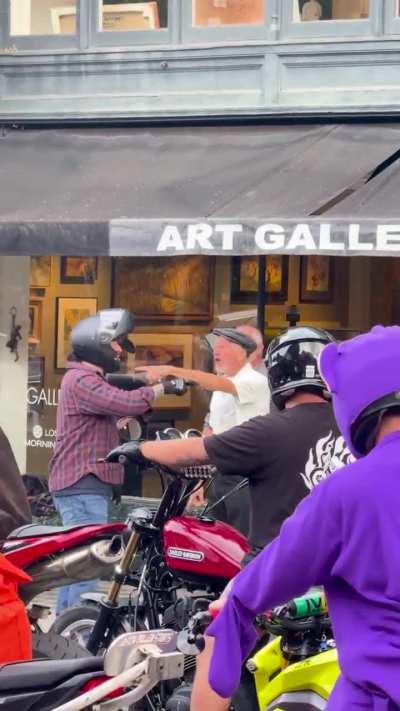 Fight between pedestrians and motorcyclists today as group passes through downtown