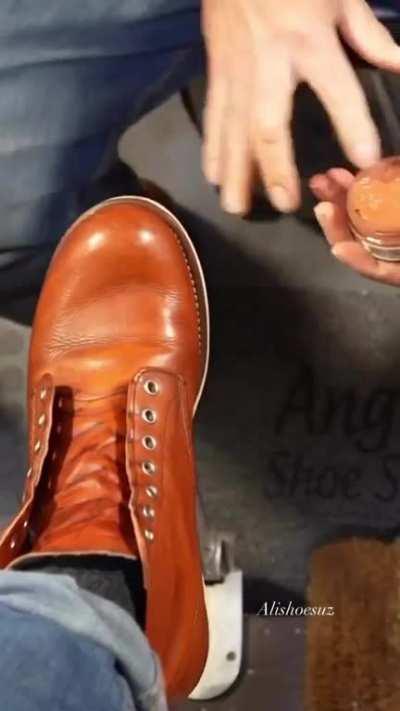 Shoeshiner working on a pair of boots