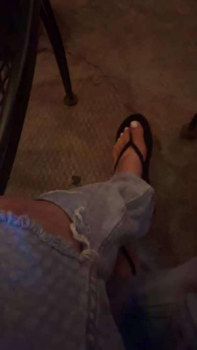 Showing off my flip flops at the bar 