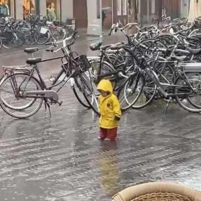 kid enjoying the rain