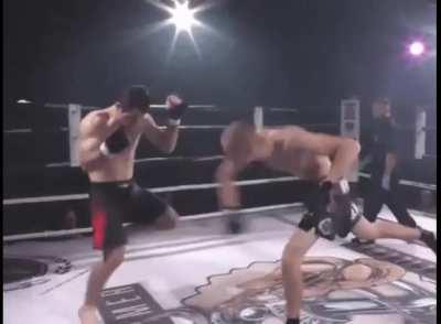 Fighter helps opponent relocate shoulder. Real sportsmanship.