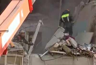 Building collapses onto emergency workers who were clearing debris after an earlier gas explosion on the outskirts of Moscow.