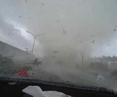 White car cuts off driver and gets swallowed by a tornado