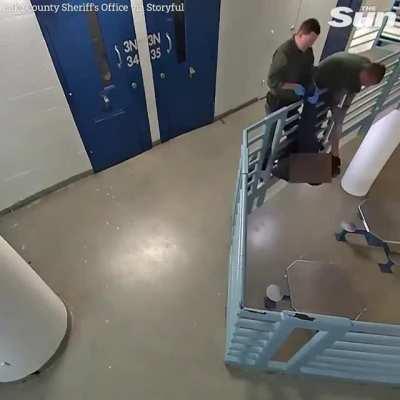 Dramatic moment hero prison officers save an inmate trying to jump over railing.