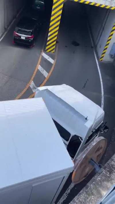 Truck entering a narrow tunnel after a precise turn