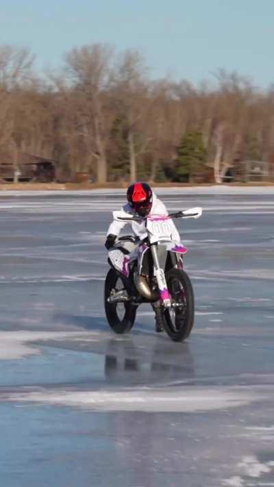 Guy rides a dirt bike on frozen lake