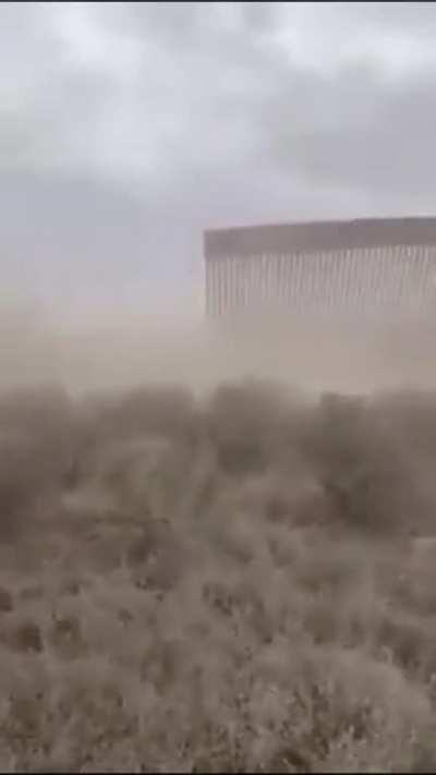 Trump’s wall on the Mexican border collapsing due to High winds.