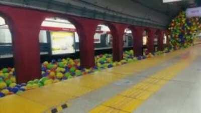 train vs 1000 colorful balls