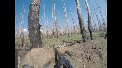 Colombian soldier using a machine gun to defend his Ukrainian position, survives FPV drone attack. Kharkiv Oblast.