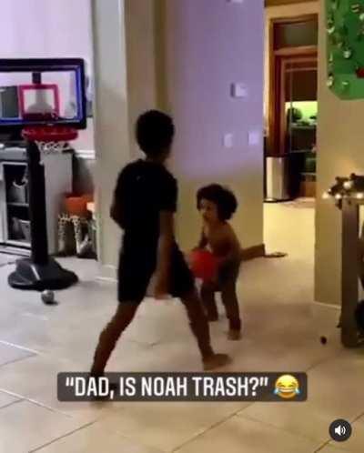 Toddler handles his big brother in basketball