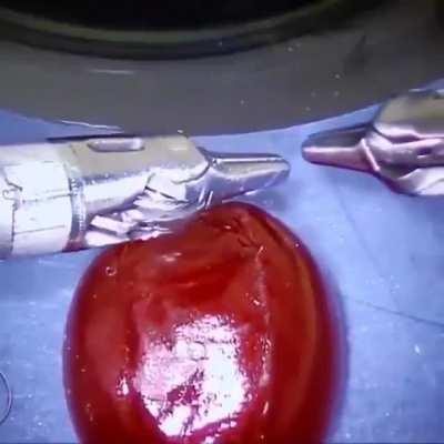 A surgeon shows the accuracy of an operation on fruits