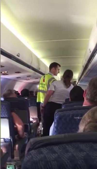 American Airlines passenger escorted off the flight.