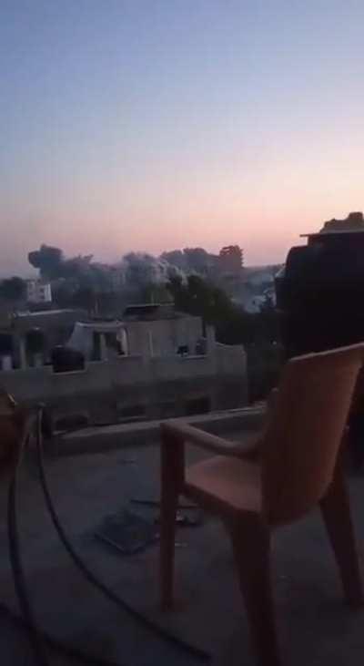 Palestinians cassually watch huge Israeli air strike on enemy building