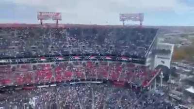 Cockpit view of low level fly through a packed NFL stadium